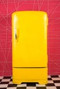 Old vintage yellow refrigerator on a pink background Royalty Free Stock Photo