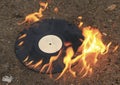 The old vinyl black plate burns on a stone surface Royalty Free Stock Photo