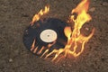 The old vinyl black plate burns on a stone surface Royalty Free Stock Photo