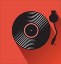 Old vinyl record and turntable on a red background