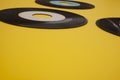 Old Vinyl 45 rpm Records on yellow background Royalty Free Stock Photo