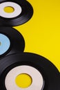 Old Vinyl 45 rpm Records on yellow background Royalty Free Stock Photo