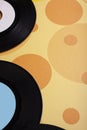 Old Vinyl 45 rpm Records on yellow background Royalty Free Stock Photo