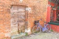 Old violet bicycle parked long an external wall in Burano island Royalty Free Stock Photo