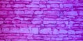 Old violet purple brick wall texture closeup pink stone blocks wall relief template Background Royalty Free Stock Photo