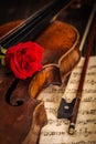 Old violin and bow with red rose Royalty Free Stock Photo