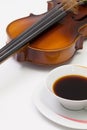 Old violin and cup of coffee on the white table Royalty Free Stock Photo