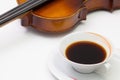 Old violin and cup of coffee on the white table Royalty Free Stock Photo