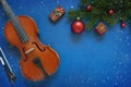 Old violin and fir-tree branches with Christmas decor. Christmas, New Year`s concept. Top view, close-up Royalty Free Stock Photo