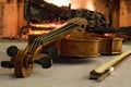 Old violin by the fireplace Royalty Free Stock Photo