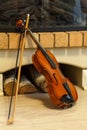 Old violin by the fireplace Royalty Free Stock Photo