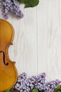 Old Violin and lilac flowers on white wooden background. Stringed musical instrument, top wiev, Love spring background Royalty Free Stock Photo