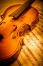 Old violin lying on the sheet of music, music concept Royalty Free Stock Photo