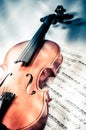 Old violin lying on the sheet of music, music concept Royalty Free Stock Photo