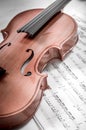 Old violin lying on the sheet of music, music concept Royalty Free Stock Photo