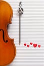 Old violin, pencil treble clef shape and red heart figurines. Top view, close up, flat lay on white music paper background Royalty Free Stock Photo