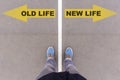 Old vs new life text arrows on asphalt ground, feet and shoes on Royalty Free Stock Photo
