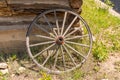 Old Wagon Wheel against Cabin Wall Royalty Free Stock Photo