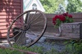 Old Wagon Wheel leaning on Rustic Bench Royalty Free Stock Photo