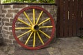 Old wagon wheel with metal rim leaning Royalty Free Stock Photo