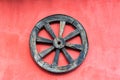Old Wagon Wheel and Red Wall Royalty Free Stock Photo
