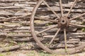 Old wagon wheel on the wooden fence Royalty Free Stock Photo