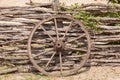 Old wagon wheel on the wooden fence Royalty Free Stock Photo