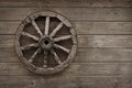 Old wagon wheel on wooden wall Royalty Free Stock Photo
