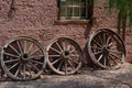 Old wagon wheels in front of a house in Calico Royalty Free Stock Photo