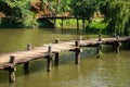 Old walking wooden bridge on lake in Vietnam