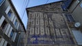 Old wall advertisement on the facade of an old building in a small village in France Royalty Free Stock Photo