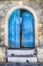 Old wall and blue wooden door, Greece Royalty Free Stock Photo