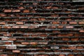 Old wall of broken bricks, wall of a collapsed building. Horizontal outside shot. Royalty Free Stock Photo