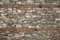 Old wall built of brick and stone, historic background Royalty Free Stock Photo