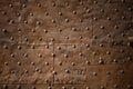 Old wall covered with sheets of rusty iron with rivets. Abstract retro background Royalty Free Stock Photo