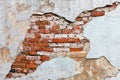 Old wall with crumbling plaster and visible masonry of red brick Royalty Free Stock Photo