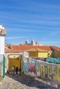 Old wall with graffiti at a cobblestoned street in Lisbon