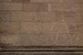 Old wall of a historical building with written anarchy sign