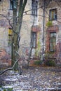 Old wall of the house with windows, peeling plaster, inside the