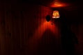 An old wall lamp in a dark wooden room Royalty Free Stock Photo