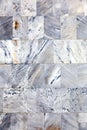 Old wall is made up of marble tiles, texture, background Royalty Free Stock Photo