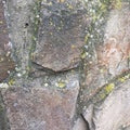 An old wall made of wild stone. Textural abstract wallpaper. Royalty Free Stock Photo