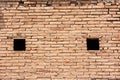 Wall of clay bricks and windows Royalty Free Stock Photo