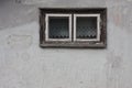 Old wall with an old wooden window with curtains