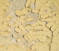 Old wall painted with yellow oil cracked paint Royalty Free Stock Photo