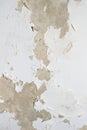 Old wall with peeling white paint. background