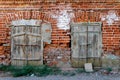 Old wall of red brick with two closed windows Royalty Free Stock Photo