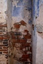 Old wall with red bricks and dark with peeling white plaster Royalty Free Stock Photo