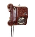 Old wall telephone with rotary dial in brown bakelite housing Royalty Free Stock Photo