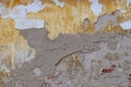 Old wall for texture or background, rough aged surface, remnants of peeling plaster, multi-colored grunge-style Royalty Free Stock Photo